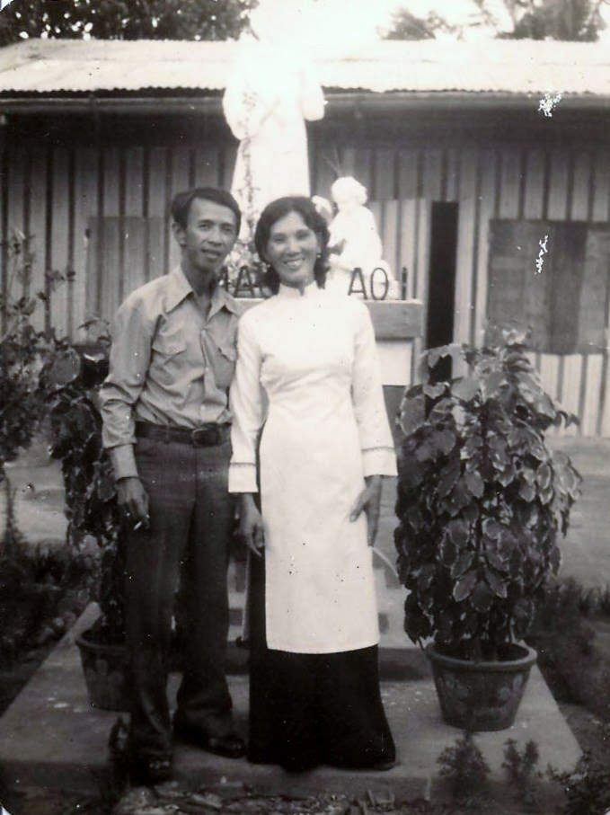 A photo of the author's parents outside their home in Tra Co. 